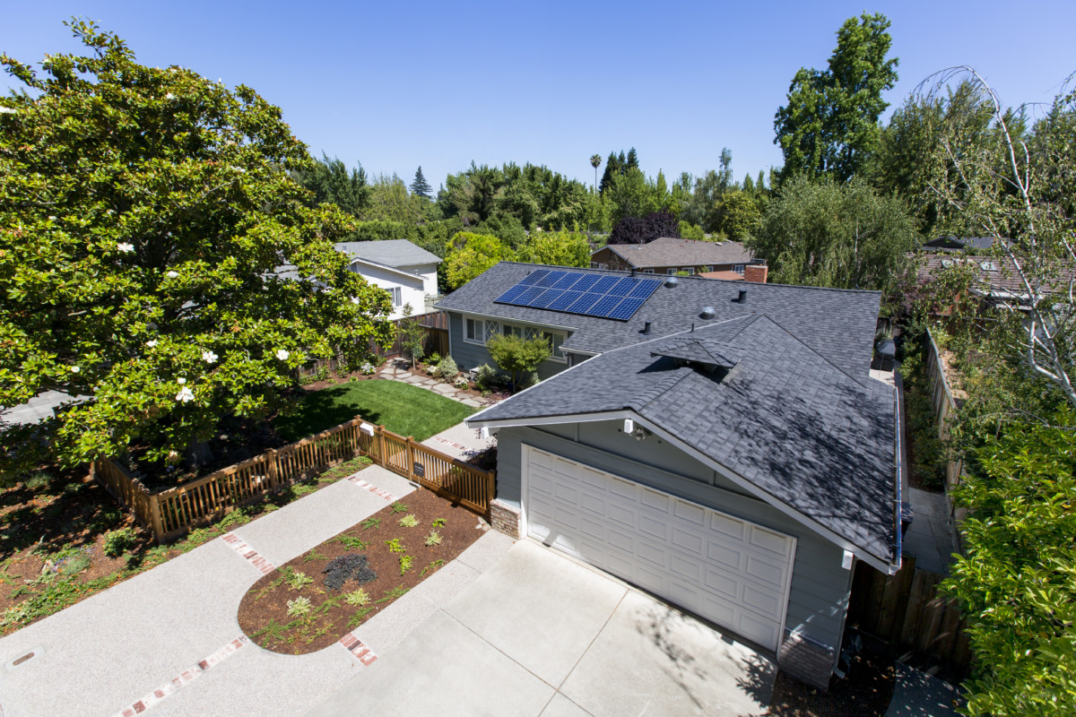 Skyview photo of a home showing solar panels installed on top of roof