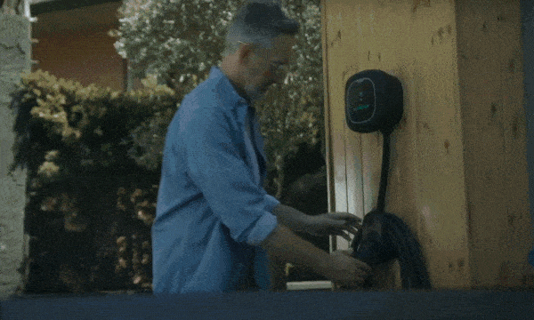 A video showing a man charging his EV at home with his Wallbox.